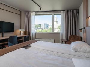 Postel nebo postele na pokoji v ubytování Quality Hotel Saga