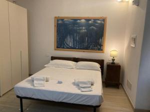 a bedroom with a bed with two towels on it at Per Due in Porto Santo Stefano