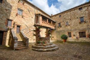a stone building with a staircase in front of it at La Badia in Sant Arcangelo
