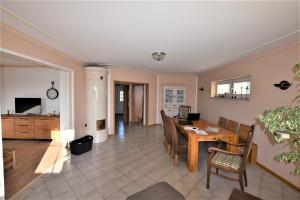 a dining room and living room with a table and chairs at Bernstein-Chalet unten in Hohwacht