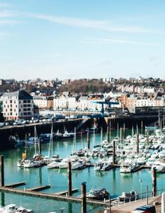 a group of boats docked in a harbor at LA TOUR AUX CRABES près de la plage in Dieppe