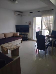 a living room with a couch and a table at Vigla House in Sykia Chalkidikis