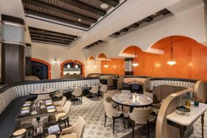 a restaurant with tables and chairs in a room at Universal's Loews Portofino Bay Hotel in Orlando