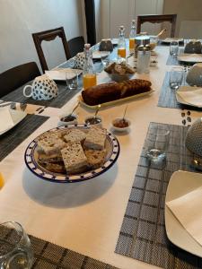a table with a plate of food on it at La Glatine - Chambres d'hôtes in Frétigny