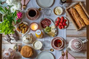 a table with breakfast foods and drinks on it at Hygge Lodge Annecy in Doussard