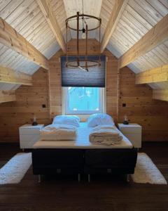 a bedroom with a large bed in a wooden room at Vakantiehuis aan bosrand in Eifel nabij Cochem-Zell aan de Moezel - Dichtbij De Calmont Klettersteig Bremm - Green House in Wagenhausen