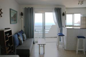 a living room with a couch and a view of the ocean at APTO 1103 MESA DEL MAR in Puerto de la Madera