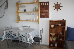 a dining room with a table and chairs and a shelf at APTO 1103 MESA DEL MAR in Puerto de la Madera +52 photos