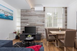 a living room with a table and a dining room at Amelia & Julia apartments in Rijeka