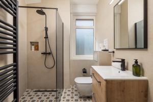 a bathroom with a shower and a toilet and a sink at Amelia & Julia apartments in Rijeka