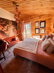 a bedroom with a large bed in a wooden room at Hygge Lodge Annecy in Doussard