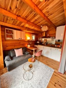 a living room with a couch and a table at Hygge Lodge Annecy in Doussard