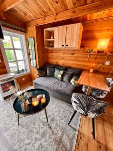 a living room with a couch and a table at Hygge Lodge Annecy in Doussard