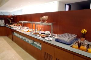 a buffet line in a hotel with food on it at Hotel Murrieta in Logroño