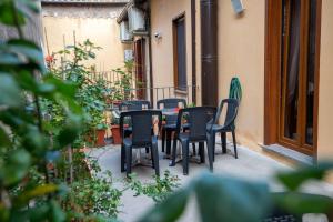 a group of chairs and a table on a patio at Dea Estia Alloggio Turistico in Tuscania