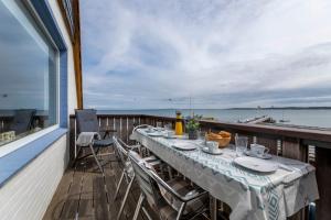 a table on a balcony with a view of the water at Luv und Lee - Über dem Meer in Hohwacht