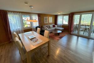 a living room with a table and a couch at Chalet Gerbera in Wengen