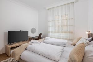a living room with two beds and a flat screen tv at Amelia & Julia apartments in Rijeka