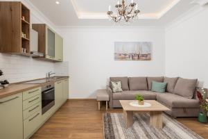a kitchen and living room with a couch and a table at Amelia & Julia apartments in Rijeka +28 photos