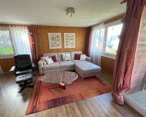 a living room with a couch and a table at Chalet Gerbera in Wengen
