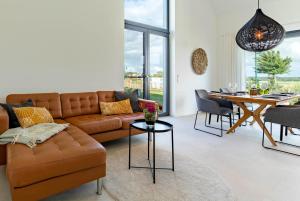 a living room with a couch and a table at Strandgänger Hohwacht in Hohwacht