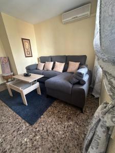 a living room with a couch and a table at Apartamento Dúplex vacacional in Burriana