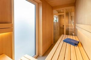 a bathroom with a shower and a blue towel at Strandgänger Hohwacht in Hohwacht +42 photos