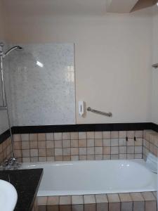 a bath tub in a bathroom with a shower at FIKARDOU ALMOND PARK in Phikardhou +38 photos