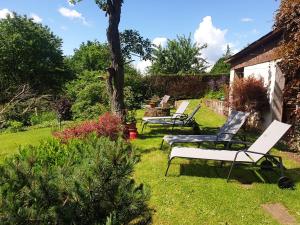 three chairs sitting in the grass in a yard at Wolfsmühle in Speckswinkel