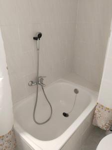 a white bath tub with a shower in a bathroom at Divertida y Romántica in Pegalajar