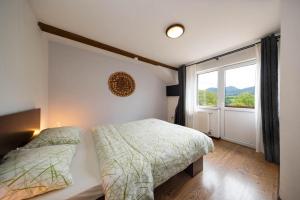 a bedroom with a bed and a large window at Cabana la Flo in Sohodol +32 photos