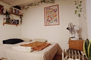a bedroom with a bed with a blanket on it at L'Art'Home à Carnon Plage in Mauguio