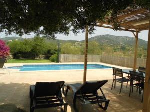 a group of chairs and a table and a swimming pool at Ses Comes de son Cladera estate in Manacor +14 photos
