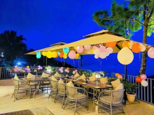 a restaurant with tables and chairs under a large umbrella at OREN Kasauli in Kasauli +181 photos
