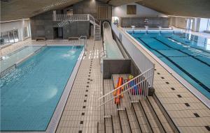 a large indoor swimming pool with a swimming pool at Lukaf in Thyborøn
