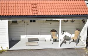 a patio with two chairs and a table on it at 4 Bedroom Lovely Home In Vikebygd in Vikebygd