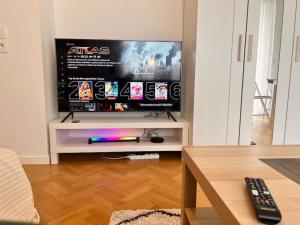 a living room with a large flat screen tv at Studio à 3 min Gare Massy-TGV in Massy