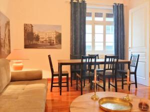 a living room with a dining room table and chairs at Elegant apartment in Syntagma square in Athens