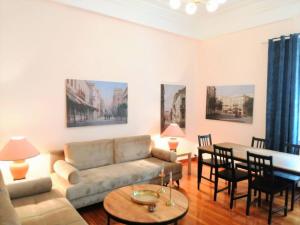 a living room with a couch and a table at Elegant apartment in Syntagma square in Athens +43 photos