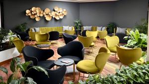 a waiting room with yellow and black chairs at Hotel Puerto Palace in Puerto de la Cruz