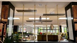 a lobby with a large glass wall at Hotel Puerto Palace in Puerto de la Cruz