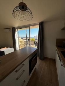 a kitchen with a counter with a view of a balcony at ROOFTOP vue mer in Vallauris