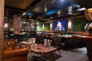a restaurant with tables and chairs and a tv at Jakz Hotel in Herten