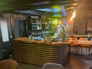 a bar in a restaurant with tables and chairs at Jakz Hotel in Herten