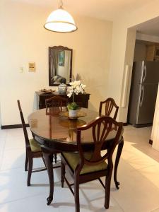 a dining room with a wooden table and chairs at royal at courtleigh towers in Kingston