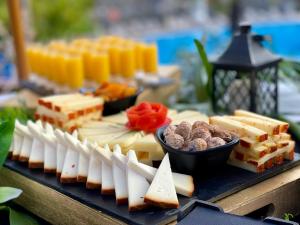 a tray of cheese and other foods on a table at Hotel Puerto Palace in Puerto de la Cruz