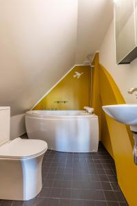 a bathroom with a toilet and a sink at Mönus Pesa in Kuressaare +38 photos