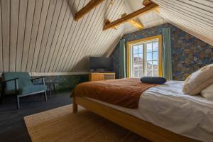 a bedroom with a bed and a desk and a window at Mönus Pesa in Kuressaare