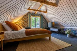 a bedroom with a bed and a television in a attic at Mönus Pesa in Kuressaare