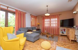 a living room with a couch and a tv at Holiday Home Grubine With Fireplace 10 in Grubine
